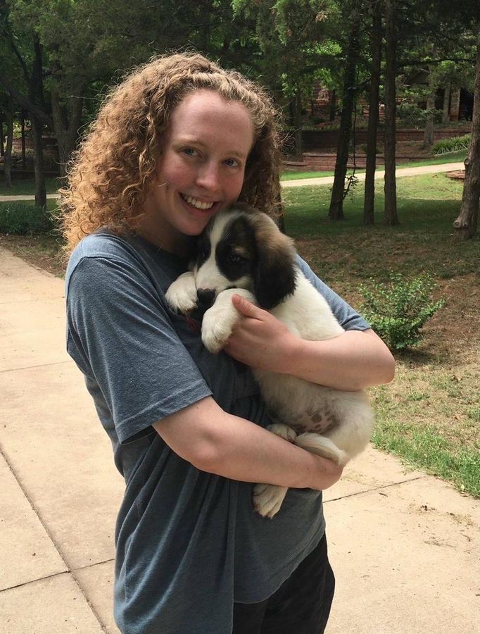 Kristine Johnson holding Chicken Nugget as a puppy